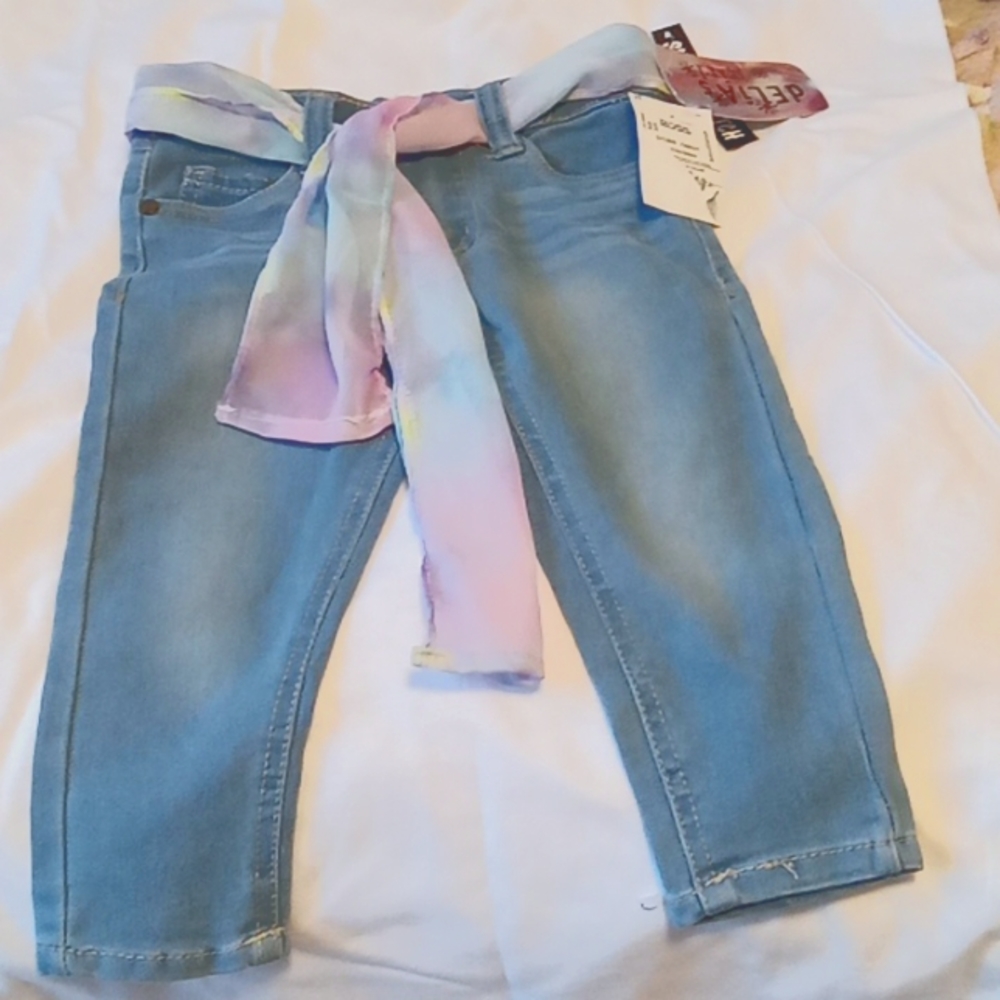 Delia*s girl blue jeans with multi colored ribbon.    Size 2t